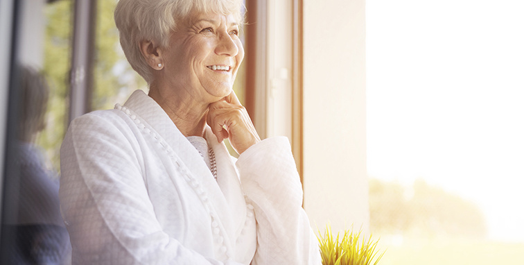 Elderly woman sitting by the window